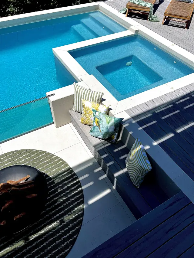 Pool and spa area with fire pit, tropical cushions and composite timber decking