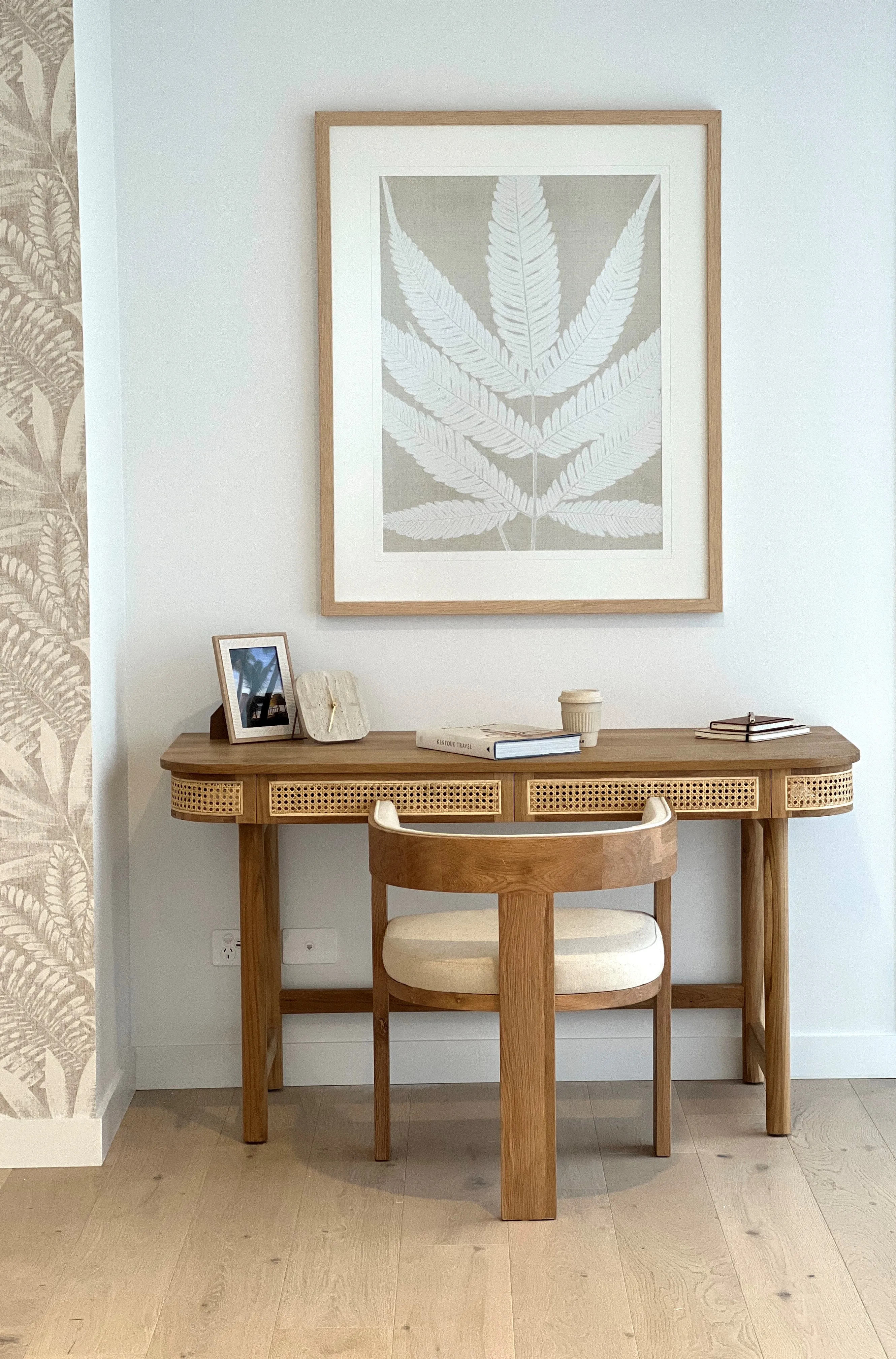 Study nook with oak and cane desk, botanical print and curved timber chair